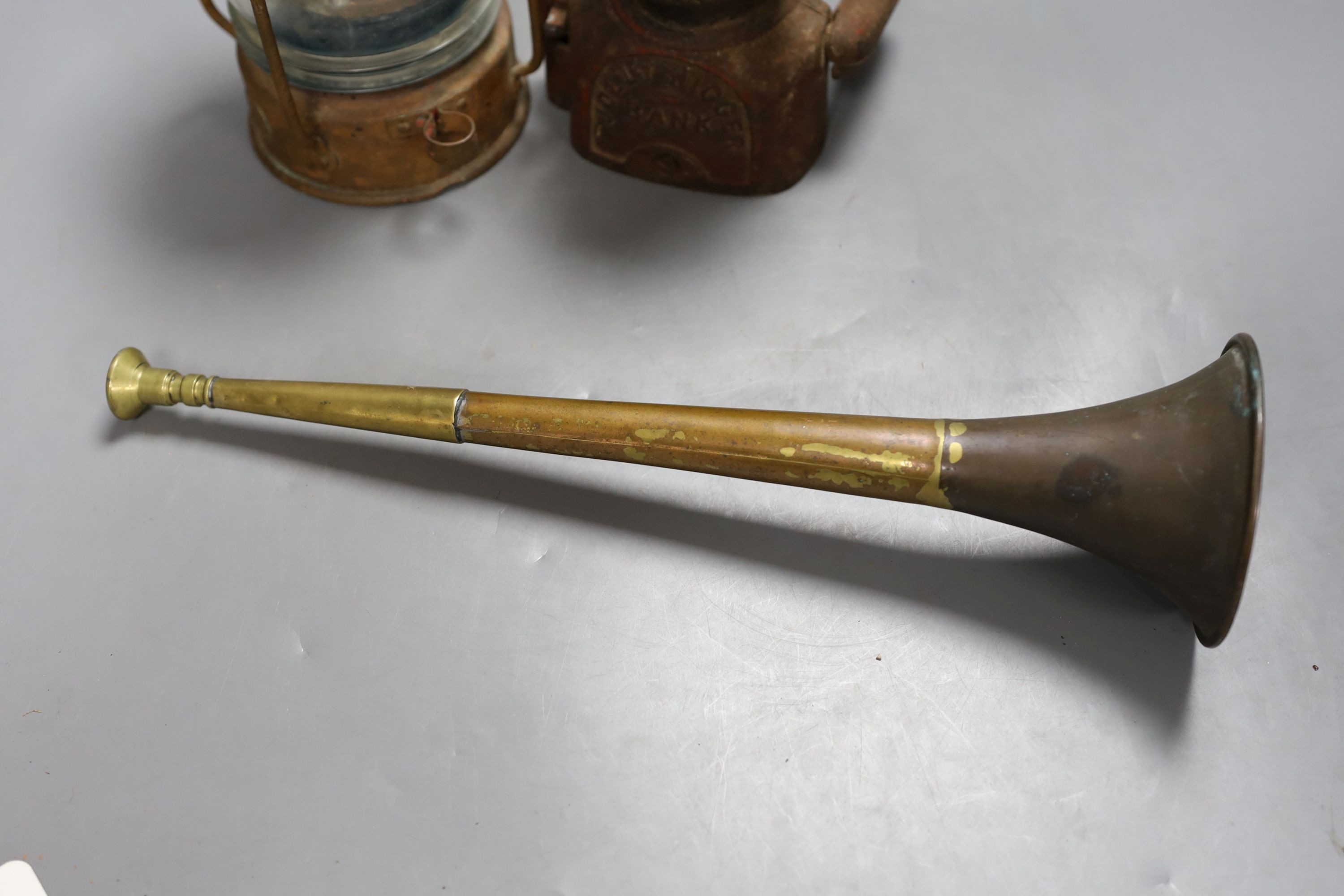 A cast money bank, copper horn and a ship's lamp, 20 cms high.